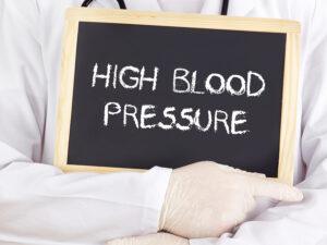 Doctor shows information on blackboard: high blood pressure